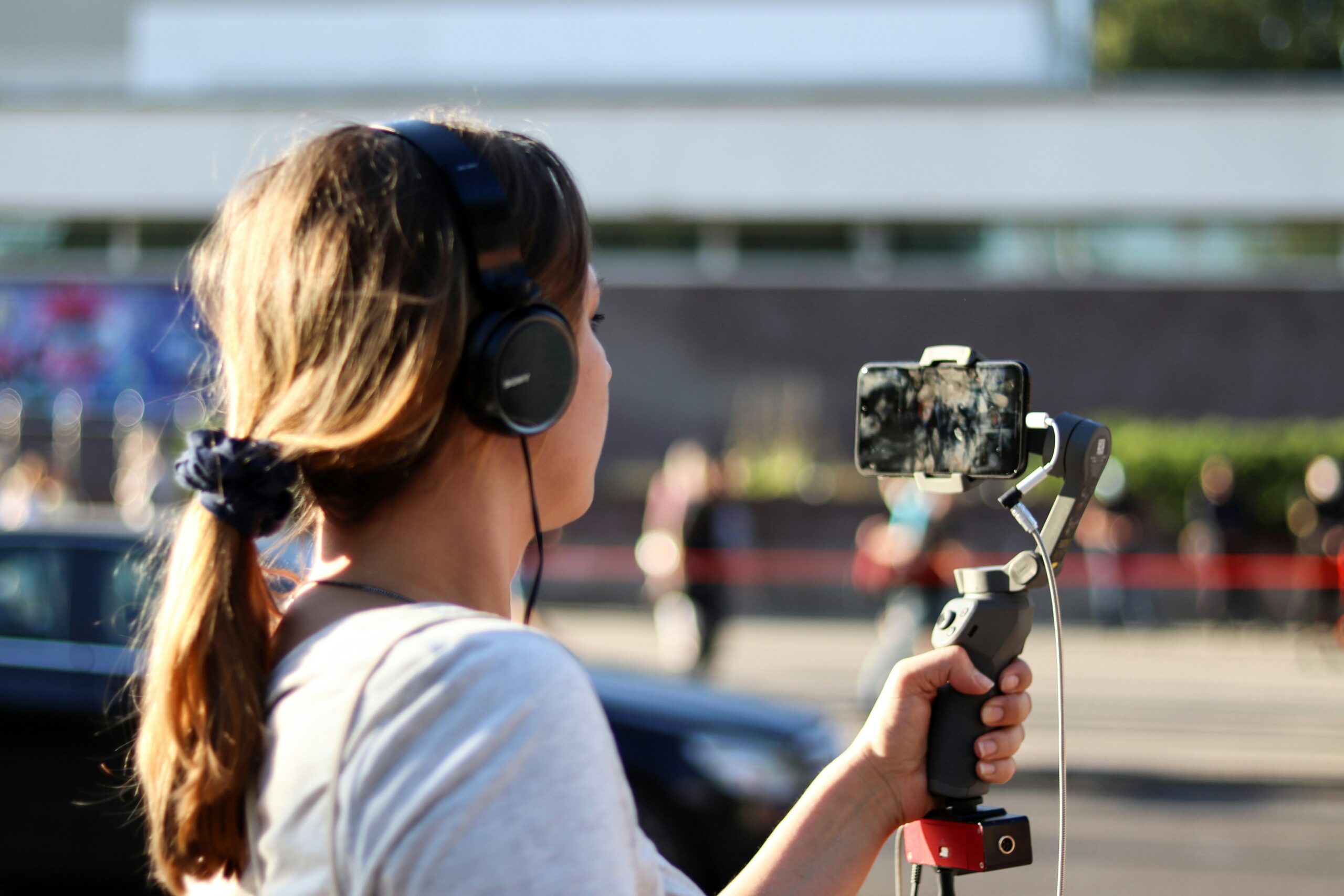 woman in white shirt holding black dslr camera